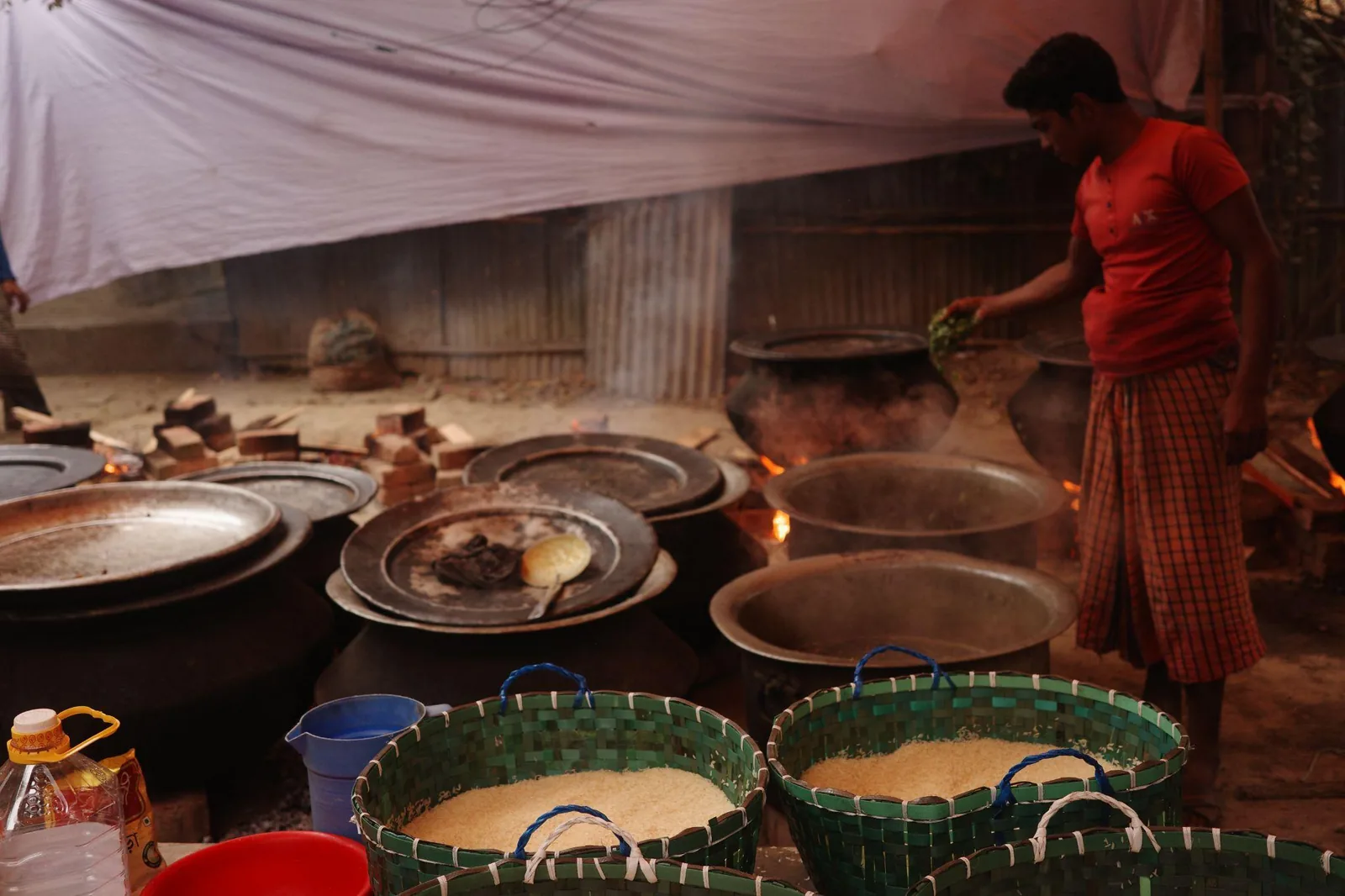 The outdoor kitchen during the Mezban, several pots going at once