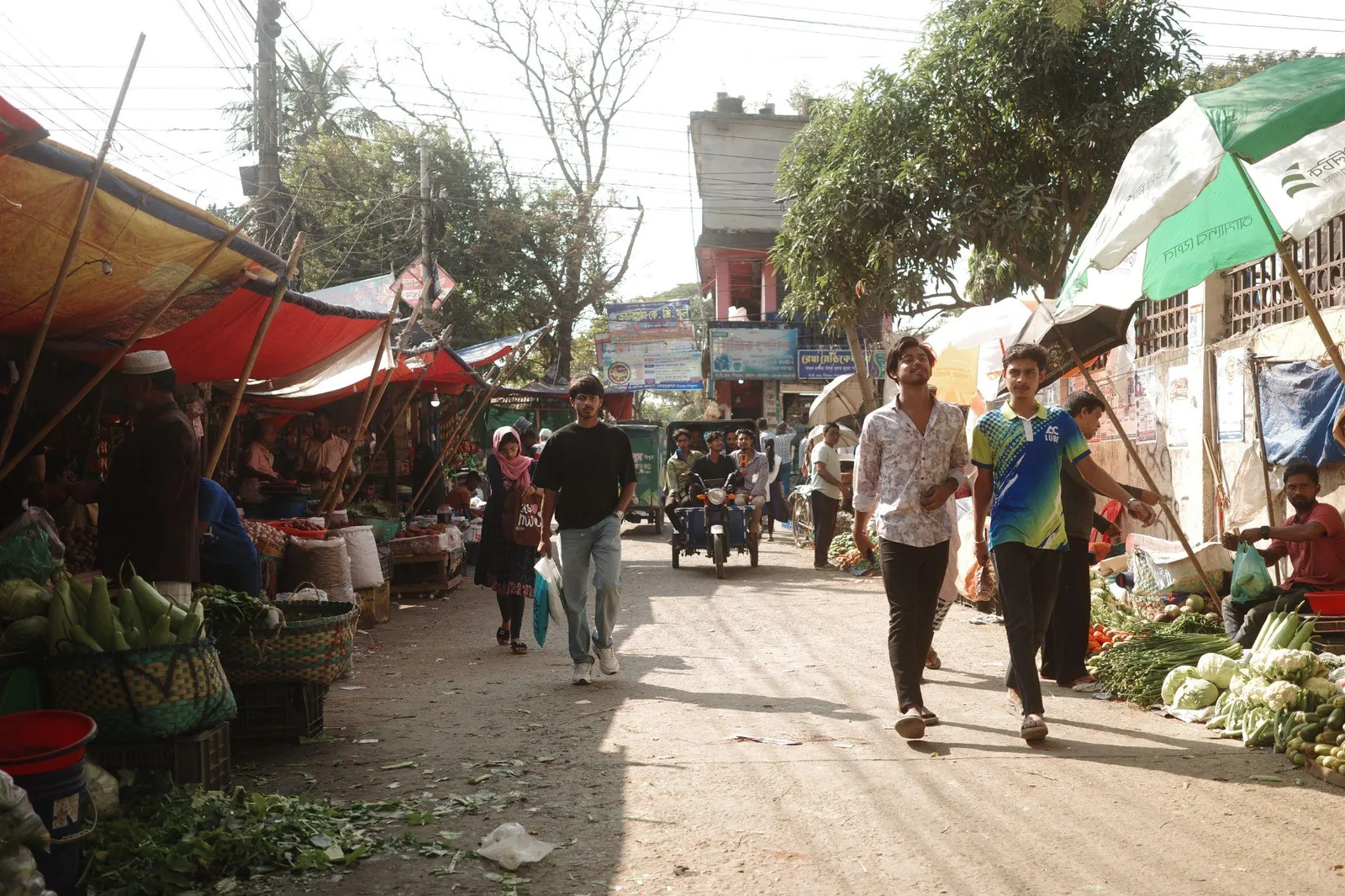 The market street, awnings on both sides, people walking through